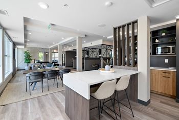 A modern kitchen with a dining table and chairs.